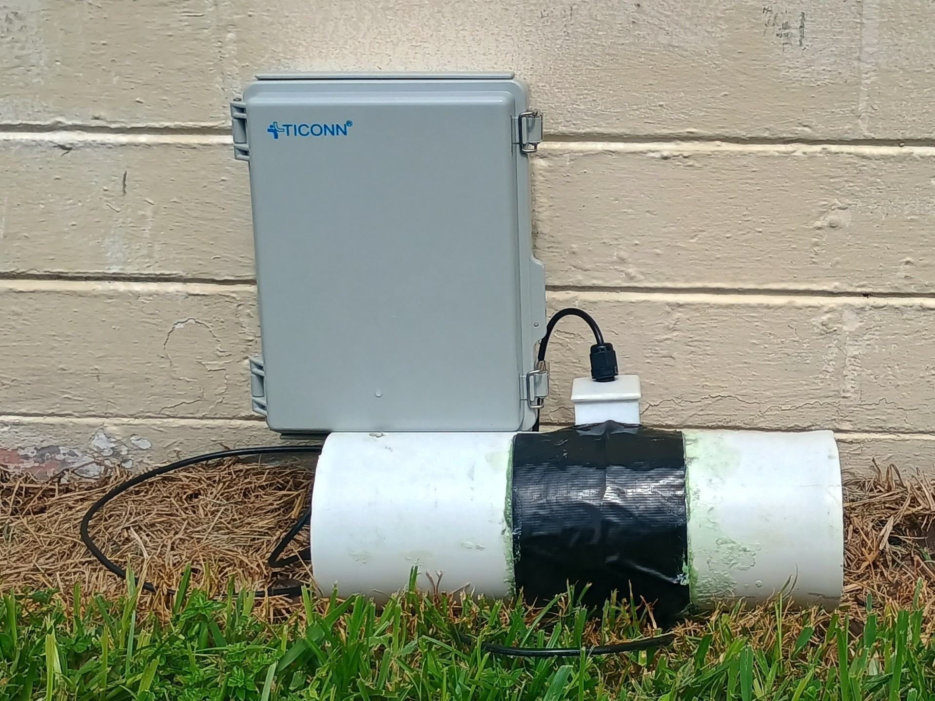 TankSense sensor and control box installed on a PVC pipe